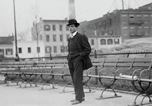 Umberto Blaisie standing in front of park benches, 1910. Creator: Bain News Service