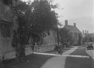 Kitty Prints: Unidentified 4-seater tourer in a village, c1920s. Artist: Bill Brunell