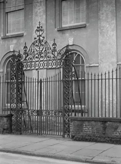 Unidentified building behind a fence, New Orleans or Charleston, South Carolina, c1920-1926. Creator: Arnold Genthe