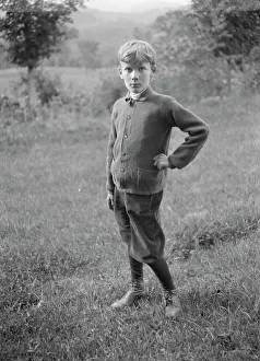 Unidentified child, standing outdoors, between 1896 and 1942. Creator: Arnold Genthe