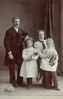 Parents Prints: Unidentified family with two girls holding dolls. Creator: Priyalalls Photography