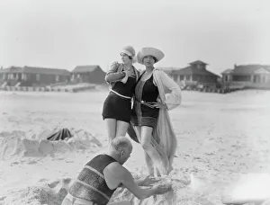 Social Life Prints: Unidentified man building sand castle and two women