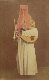 Unidentified man in long hood holding a candle and book, standing, about 1870. Creator: Giorgio Conrad