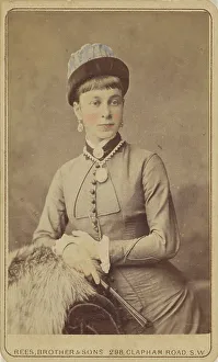 Unidentified woman standing, holding a fan, 1879. Creator: David Rees & Brother & Son