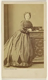 Unidentified woman standing, leaning against a credenza, about 1861. Creator: Bayard & Bertall