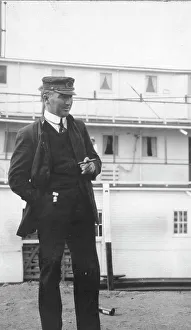 Yukon Prints: Uniformed man smoking a cigar, between c1900 and 1916. Creator: Unknown