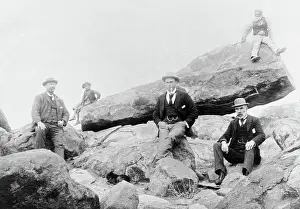 Lestrange Robert Augustus Henry Prints: Unknown men and boy, unknown location posing on large rocks, c1900s