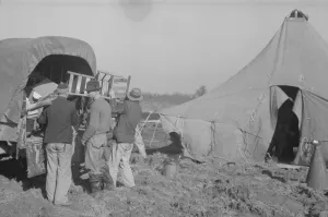 Bad Weather Gallery: Unloading the household goods of a family who is being... Forrest City, Arkansas, 1937