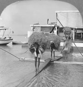 Landing Stage Prints: Unloading a vessel on the Irrawaddy River, Burma, 1908. Artist: Stereo Travel Co