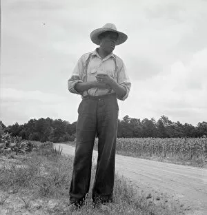 Straw Hat Collection: Untitled, 1935-1942. [African-American man near a field of corn]. Creator: Unknown