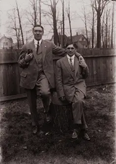 Backyard Prints: Untitled (two men holding small dog; one sitting on a stump)