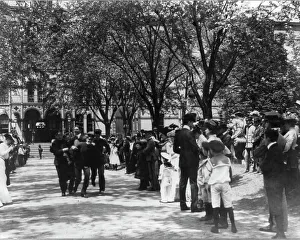 Naval Academy Prints: U.S. Naval Academy, Annapolis: 4 midshipmen carrying a man; crowd of guests along sidewalk