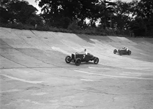 Vauxhall 30 / 98 and Bugatti Type 37 racing on the banking at Brooklands. Artist: Bill Brunell