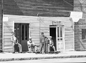 Sidewalk Gallery: Vicksburg Negroes and shop front, Mississippi, 1936. Creator: Walker Evans