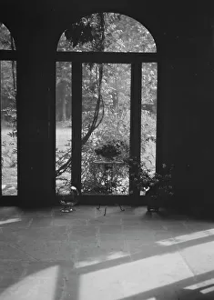 Interiors Prints: View through arched window into a courtyard