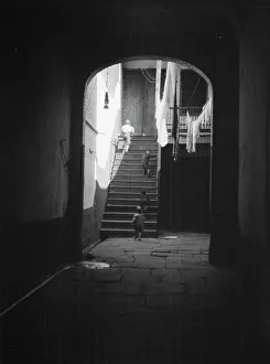 Clothes Line Prints: View of a courtyard through an arched passageway