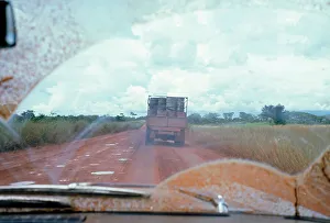 Dirty Prints: View through muddy windsreen on African dirt road