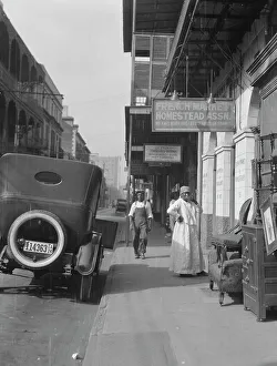 Bib Overalls Prints: View down a street, New Orleans, between 1920 and 1926. Creator: Arnold Genthe