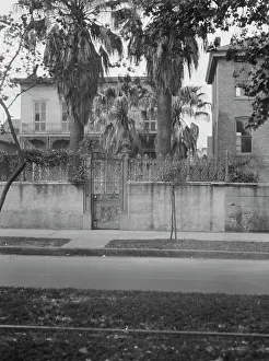 City Garden Prints: View from across street of two-story house behind wall