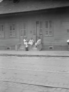 Shutters Prints: View from across street of three women talking