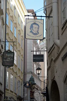 Detail view of the traditional signs along an old building on Getreidegasse, Salzburg, Austria, 2022 Creator: Ethel Davies