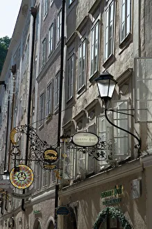 Street Lighting Prints: Detail view of the traditional signs along an old building on Getreidegasse