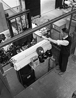 Nottinghamshire Prints: Warehouseman loading a fork lift truck in the stores