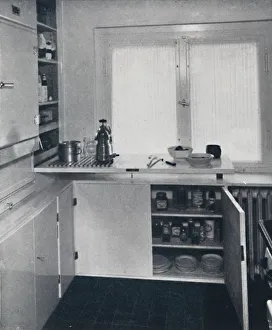 Space Saving Prints: Werner Harting - Kitchen with a black Dutch tiled floor, white walls and built-in shelves