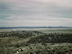 West-bound passenger train going around a curve on the Atchison..., near Gleed, Arizona, 1943. Creator: Jack Delano West-bound passenger train going around a curve on the Atchison..., near Gleed, Arizona, 1943. Creator: Jack Delano
