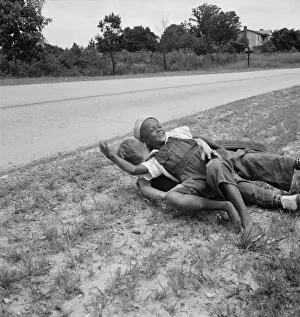 Racism Collection: White and Negro boy wrestling by side of road, Person County, North Carolina, 1939