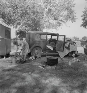 Refugee Camp Prints: Wife of migratory worker in auto camp, California, 1936. Creator: Dorothea Lange