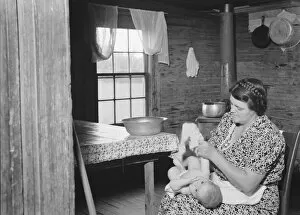 Wife of tobacco sharecropper bathing her baby... Person County, North Carolina, 1939. Creator: Dorothea Lange