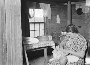 Soft Furnishing Collection: Wife of tobacco sharecropper bathing baby in kitchen, Person County, North Carolina, 1939