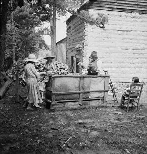 Wives of tobacco tenants pile the tobacco... Granville County, North Carolina, 1939. Creator: Dorothea Lange