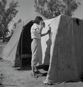 Mending Prints: Woman in a California pea pickers camp, mending the tent, 1937. Creator: Dorothea Lange