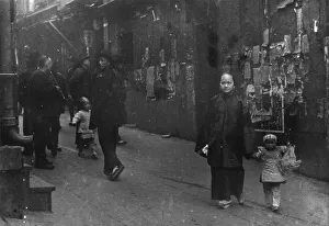 Chinese Americans Prints: Woman and a child walking down a street