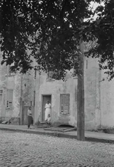 Woman and children standing in or by a doorway, [17 Chalmers Street], Charleston... c1920-c1926. Creator: Arnold Genthe
