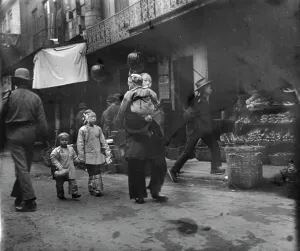 Woman and children walking down a street, Chinatown, San Francisco, between 1896 and 1906. Creator: Arnold Genthe