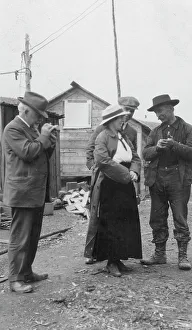 Settlers Prints: Woman and three men talking outside, between c1900 and 1916. Creator: Unknown