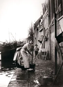 Woman mopping the street, Dordrecht, Netherlands, 1898. Artist: James Batkin