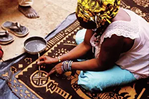 Cotton Prints: Woman painting with mud from the River Niger, Djenne, Mali, 1990. Creator: Amanda Waite