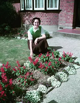 Garden Design Prints: Woman proudly showing off her flower bed, c1955. Creator: Arthur Charles Kirby Ware