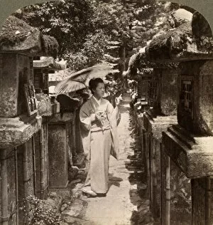 A woman Shinto devotee counting the stone lanterns, Kasuga Shrine, Nara, Japan, 1904.Artist: Underwood & Underwood
