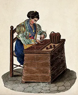 Coins Prints: A woman sits at a wooden box counting money out of a basket onto a tray. Creator: Unknown