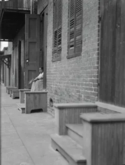 Woman sitting on steps, New Orleans or Charleston, South Carolina, between 1920 and 1926. Creator: Arnold Genthe