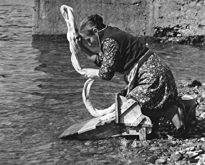 Washing Prints: Woman washing clothes in a river, Portugal, 1973