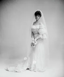 Woman in wedding dress holding flowers, between 1900 and 1910. Creator: Unknown