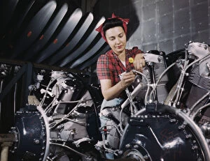 Assembly Line Methods Collection: Woman working on an airplane motor at North American Aviation, Inc. plant in Calif. 1942