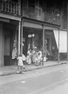 Balcony Rail Prints: Women and children standing on a covered sidewalk