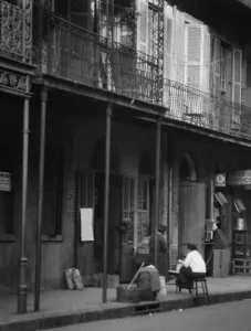Grocers Prints: Women on a covered sidewalk, New Orleans, between 1920 and 1926. Creator: Arnold Genthe
